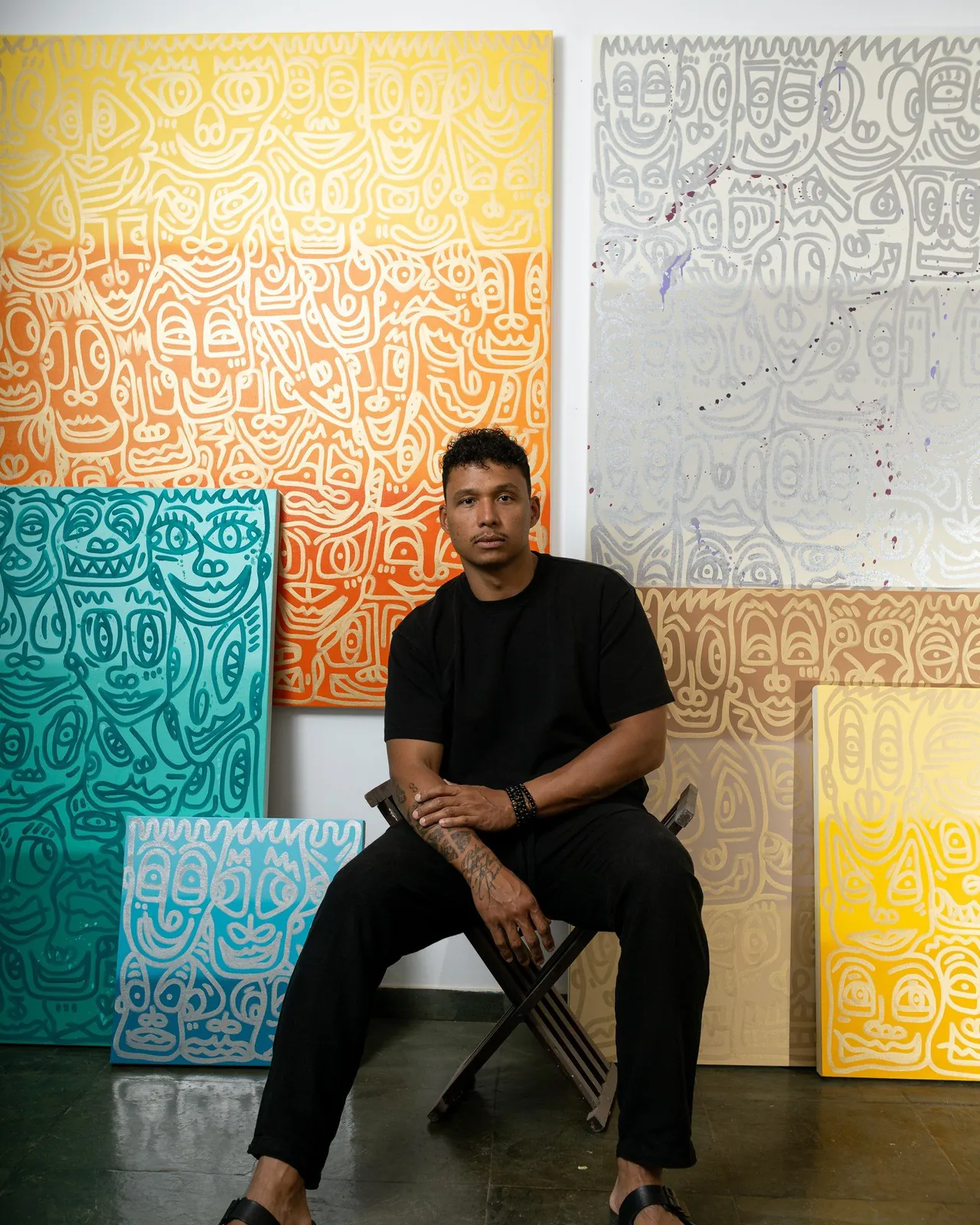 Romulo Kuranyi in front of his canvases
